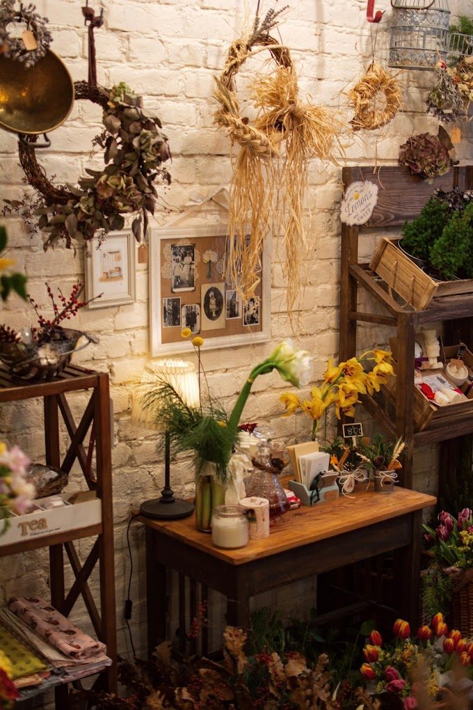 Dried wreaths and flowers along the white brick wall at Chez Gizza